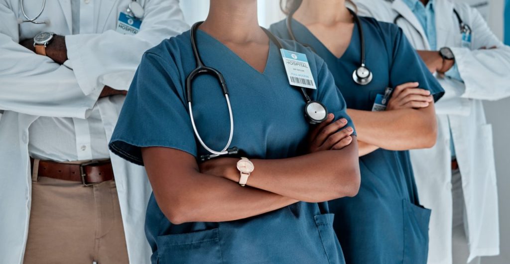 group of doctors standing with their arms crossed while working at a hospital expert medical profe