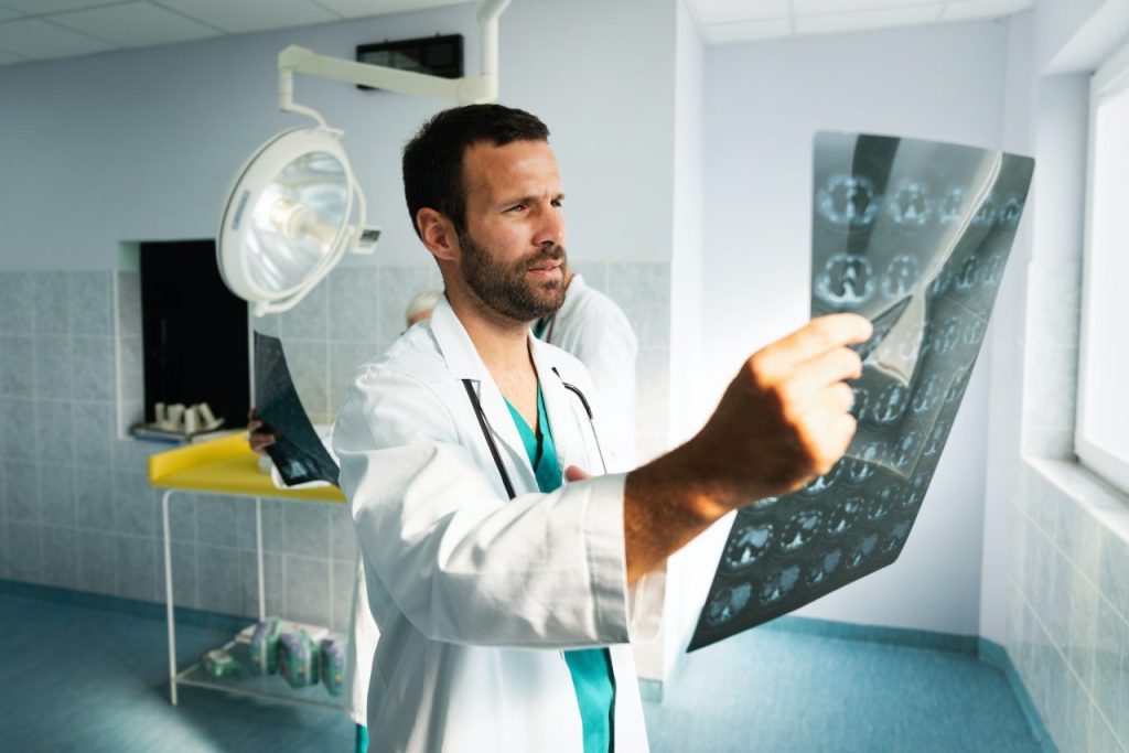 radiologist doctor examining x ray images of patient for diagnosis